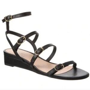 Stuart Weitzman Grecian Buckle Wedge Sandal In Black Leather